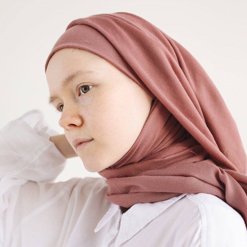 Close-Up Photo of a Young Woman Posing in White Long Sleeve Shirt and Brown Hijab